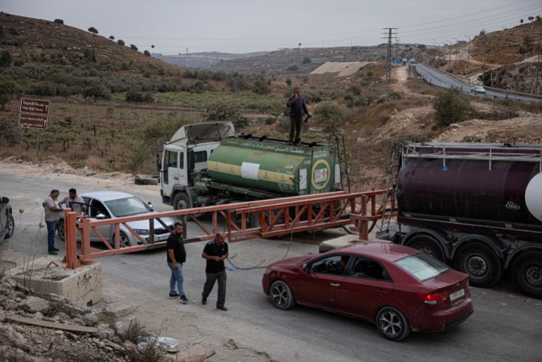 getty_6ae07409ce-1793094665 HEBRON, WEST BANK - OCTOBER 26: Palestinians transfer fuel from one tank to another at a closed gate at one of the entrances to Hebron on October 26, 2026 in Hebron, West Bank. Following a deadly shooting at a checkpoint last Friday, the Israeli military has launched a widespread military crackdown in the occupied West Bank city of Hebron. This has resulted in the displacement of over 3,000 Palestinians and the widespread demolition of homes, factories, and infrastructure. (Photo by Faiz Abu Rmeleh/Getty Images)