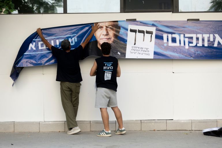 getty_6ae0c3deea-1793115102 HERZLIYA, ISRAEL - OCTOBER 27: Yahsar Party activists hang a campaign poster featuring chief of staff and Yashar Party leader, Gadi Eisenkot, during Israel's general elections on October 27, 2026 in Hezliya, Israel. Voters are heading to the polls in Israel to elect 120 members of the Knesset, which will determine the make-up of the government that succeeds incumbent Prime Minister Benjamin Netanyahu's right-wing coalition. The legislative elections are the first to be held since the Hamas-led attacks against Israel on October 7, 2023. (Photo by Amir Levy/Getty Images)