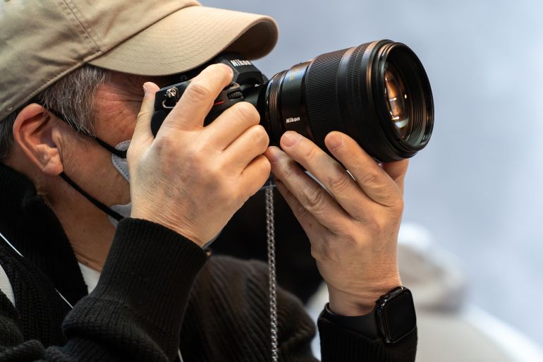 gettyimages-2202256558-1791307322 YOKOHAMA, JAPAN - FEBRUARY 27: An attendee tries out a mirrorless digital camera in the Nikon booth during the CP+ (CP Plus) 2025 show on February 27, 2025, in Yokohama, Japan. One of the world's largest trade shows for camera, lens and imaging products is held through March 2. (Photo by Tomohiro Ohsumi/Getty Images)