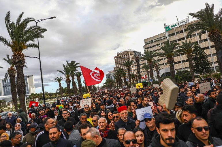 gettyimages-2247409227-1776279636 Protesters wave the Tunisian flag while shouting slogans during a mass rally organized under the slogan ''March Against Injustice'' in Tunis, Tunisia, on November 22, 2025. Organized by the support committee for imprisoned former judge and lawyer Ahmed Souab, the protest denounces President Kais Saied's policies. The demonstration, bringing together opposition political parties from across the spectrum along with Gen Z activists, human rights groups, and civil society members dressed in black, denounces what participants describe as President Saied's authoritarian and repressive rule. The Tunisian opposition, joined by local and international human rights groups, demands the release of political prisoners and condemns what they view as an assault on democracy, citing the erosion of institutions through an escalating crackdown on dissent, judicial independence, press freedom, and human rights. They warn that Saied's rule drives a broader democratic backslide. (Photo by Chedly Ben Ibrahim/NurPhoto via Getty Images)