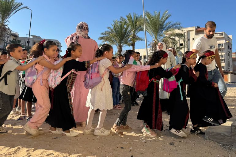 msr-ghzt-mdrst-1791155333 Displaced children from the Gaza Strip, stand in line as they attend a Palestinian school in the Egyptian city of El-Arish, near the border with the Gaza Strip, on October 1, 2026. On Egypts Sinai Peninsula, Palestinian teacher Hadeel Zourob welcomes dozens of pupils from Gaza to the only Palestinian school in the region a school she set up for these children displaced by the war. Hadeel Zourob arrived in April 2024, six months after the war began. Together with other teachers, she began teaching a small group of children in a rented building. (Photo by Amr AHMED / AFP)