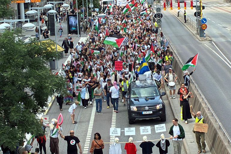 protest17-1754776319 STOCKHOLM, SWEDEN AUGUST 09: Protesters wave Palestinian flags and hold banners during a demonstration in Stockholm against the Israeli government's plan to seize Gaza and displace Palestinians on August 09, 2025 in Stockholm, Sweden. (Photo by Atila Altuntas/Anadolu via Getty Images)