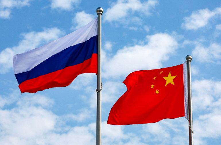 FILE PHOTO: Chinese and Russian flags fly at an airport before a ceremony to welcome Russian President Vladimir Putin, who arrives to attend the Shanghai Cooperation Organisation (SCO) summit in Tianjin, China August 31, 2025. Sputnik/Vladimir Smirnov/Pool via REUTERS ATTENTION EDITORS - THIS IMAGE WAS PROVIDED BY A THIRD PARTY./File Photo