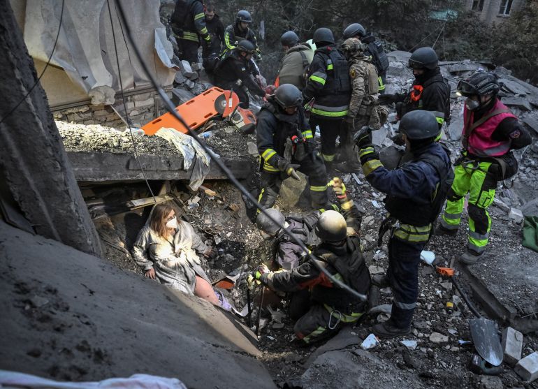 reuters_6ac9e627-1791616551-1 Rescuers evacuate wounded residents, Yana and her husband Anton, found under debris of an apartment building damaged during a Russian air strike, amid Russia's attack on Ukraine, in Zaporizhzhia, Ukraine October 10, 2026. REUTERS/Stringer