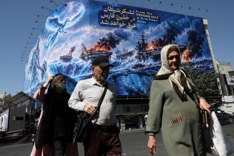 FILE PHOTO: People walk past a billboard about the Strait of Hormuz, on a building in Tehran, Iran, September 16, 2026. Majid Asgaripour/WANA (West Asia News Agency) via REUTERS ATTENTION EDITORS - THIS PICTURE WAS PROVIDED BY A THIRD PARTY. ISRAEL OUT. NO COMMERCIAL OR EDITORIAL SALES IN ISRAEL. NO ACCESS FOR ISRAELI MEDIA. NO USE BBC PERSIAN. NO USE VOA PERSIAN. NO USE MANOTO. NO USE IRAN INTERNATIONAL. NO USE RADIO FARDA. DIGITAL: NO USE BBC PERSIAN. NO USE VOA PERSIAN. NO USE MANOTO. NO USE IRAN INTERNATIONAL. NO USE RADIO FARDA./File Photo