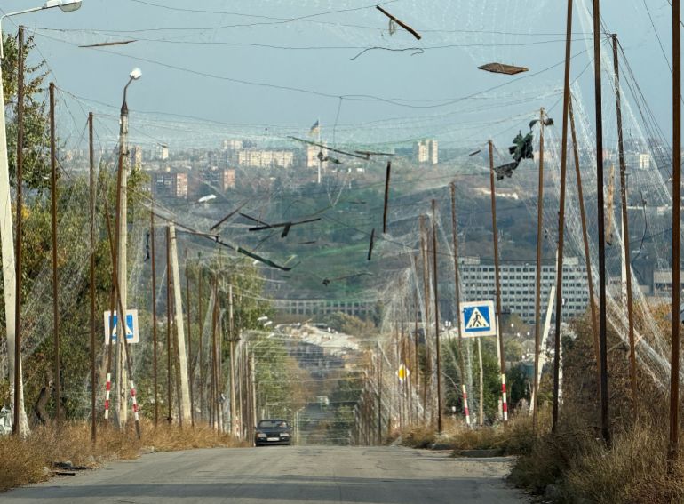A car rides on a road covered with anti-drone nets, amid Russia's attack on Ukraine, in the frontline city of Kramatorsk, Ukraine October 14, 2026. Picture taken with a mobile phone. REUTERS/Stringer