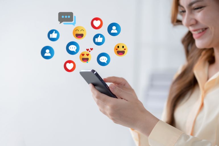send-emoji4-1733401941 Woman using smartphone sending emojis. Happy woman using phone to chat online with friends. 3d emoji icon.; Shutterstock ID 2343572279; purchase_order: aljazeera ; job: ; client: ; other: